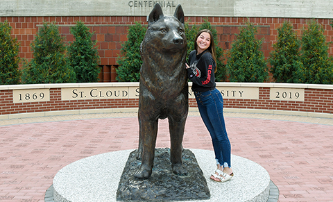 An SCSU student stands in Husky Plaza