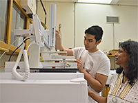 Faculty and student wokring in lab