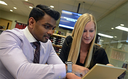 two people using a laptop computer