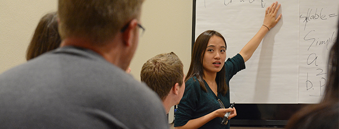 A visiting scholar from China teaches a Chinese language class.