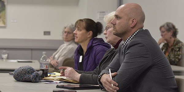 Attendees of a housing summit listen to a presenter