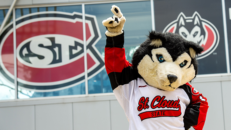 Blizzard mascot enthusiastically pointing to SCSU sign