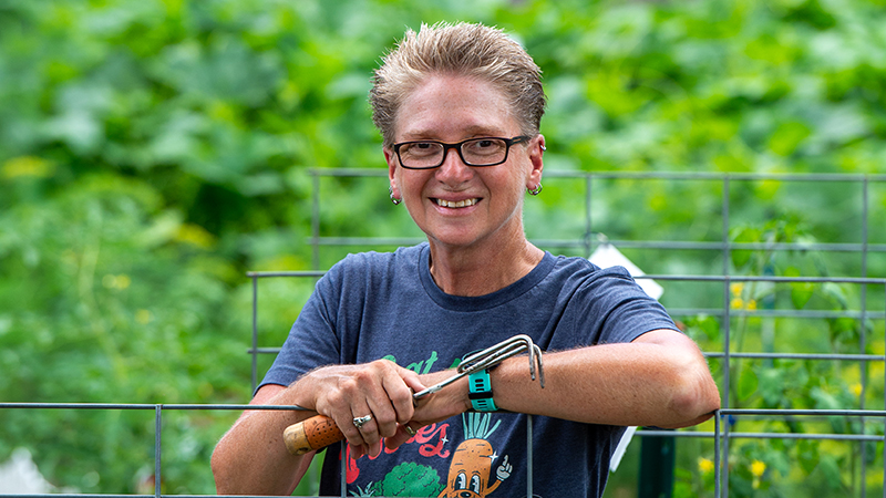 Tracy Ore standing in Community Garden