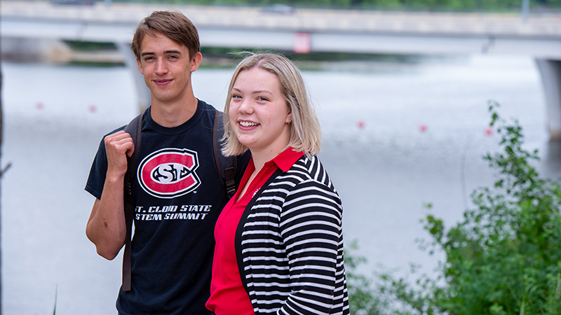 Two students by river