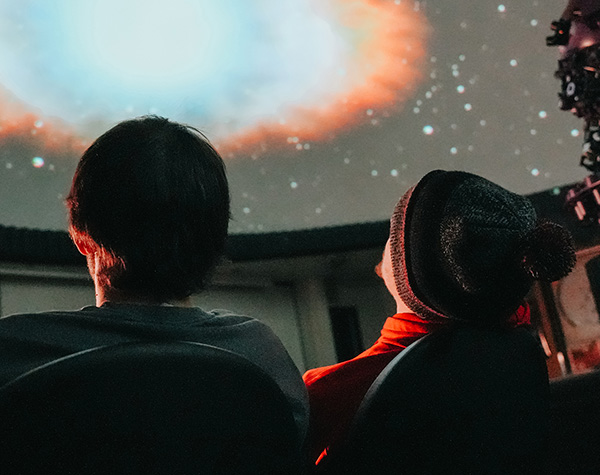 St. Cloud State University students watching a presentation in the St. Cloud State University Planetarium