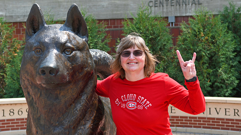 Provost Zink doing the sign of the Husky