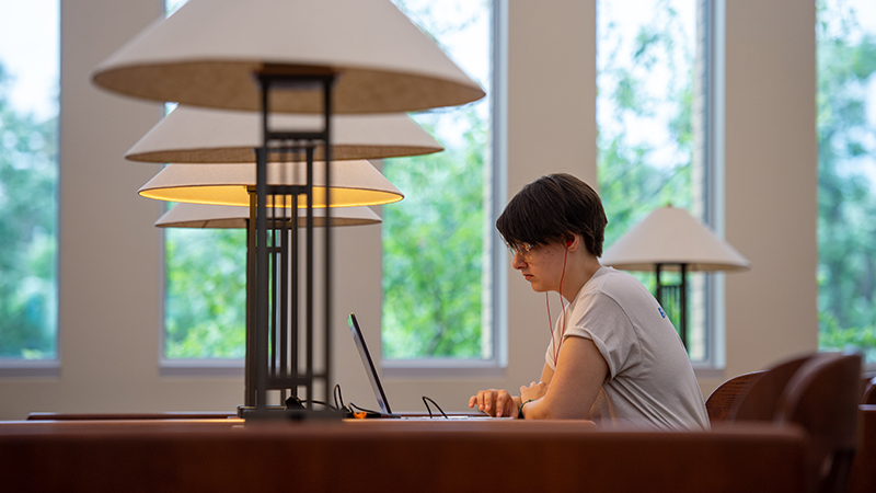 Student studying at library table