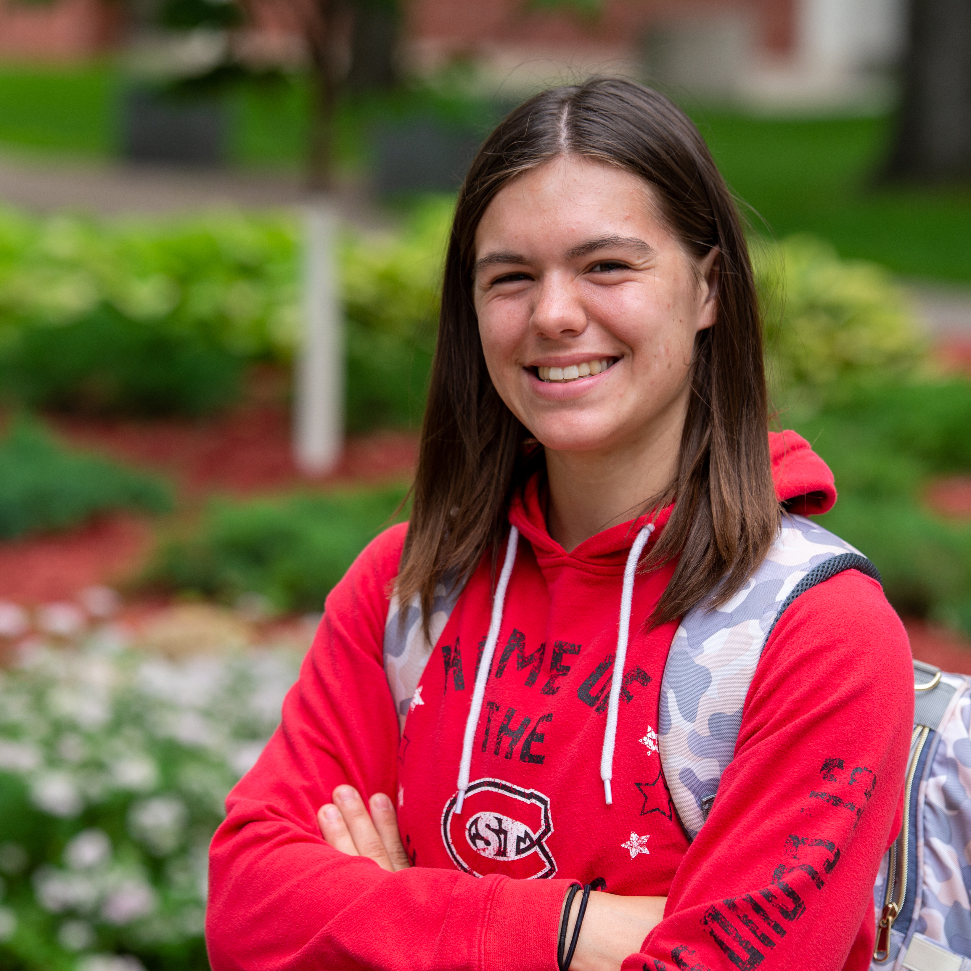 Student with backpack smiling.