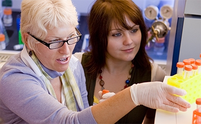 Marina Cetkovic-Cvrlje, biology professor, works with graduate students using a flow cytometer