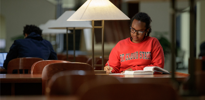 St. Cloud State student working in the James W. Miller Center Library on the St. Cloud State University campus