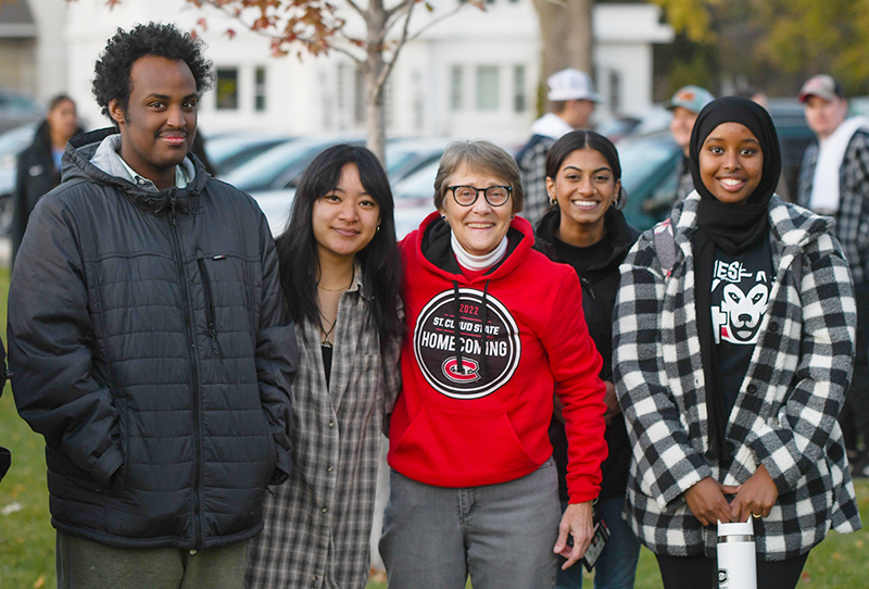 President Robbyn Wacker and students at the Homecoming bonfire