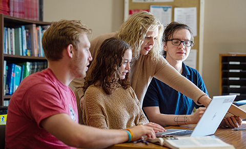 Students and faculty work on a computer at SCSU