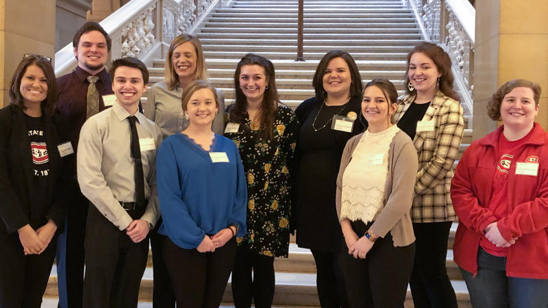 A small group of SCSU students pictured at the Minnesota Capitol building after presenting their research
