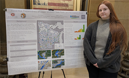 Eryn Bloom presents with her earth science poster at Posters at St. Paul
