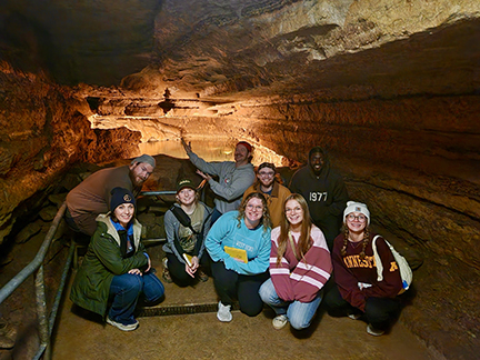 Students in a field geology course tour a cave