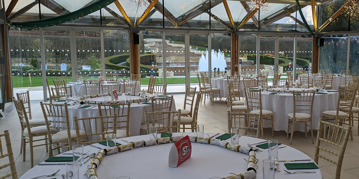 Tables set up for dinner at the Poison Gardens atrium