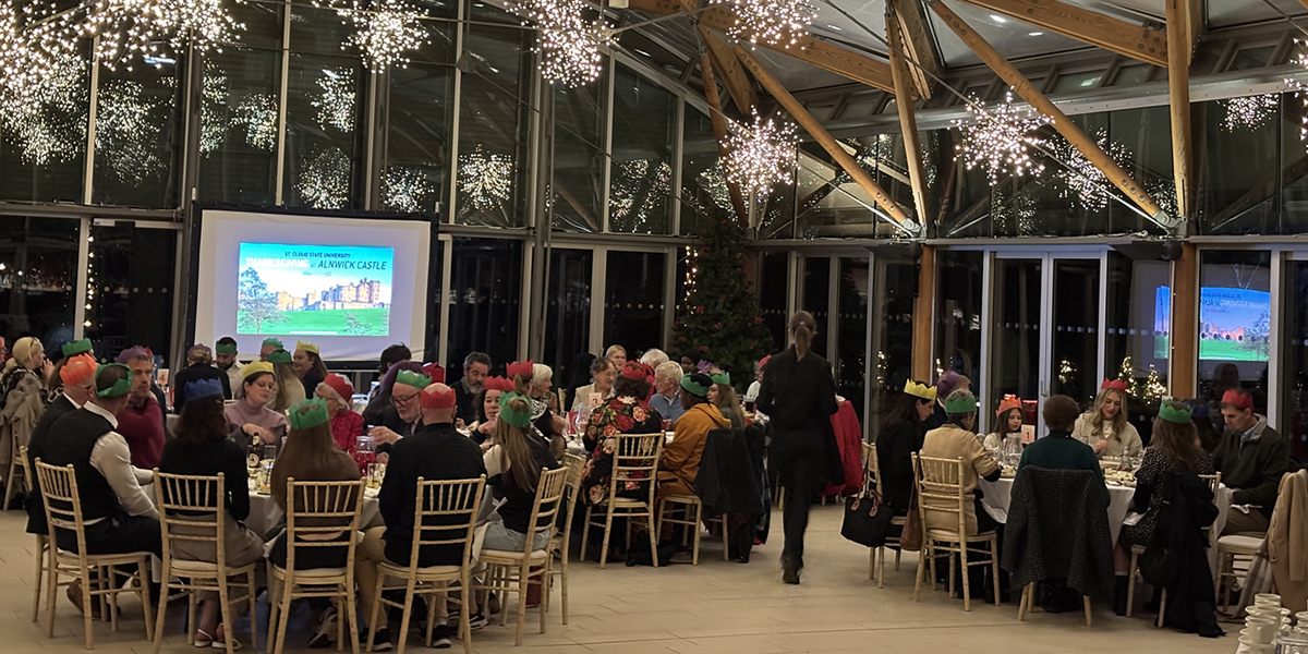 Large atrium room with people seated for dinner