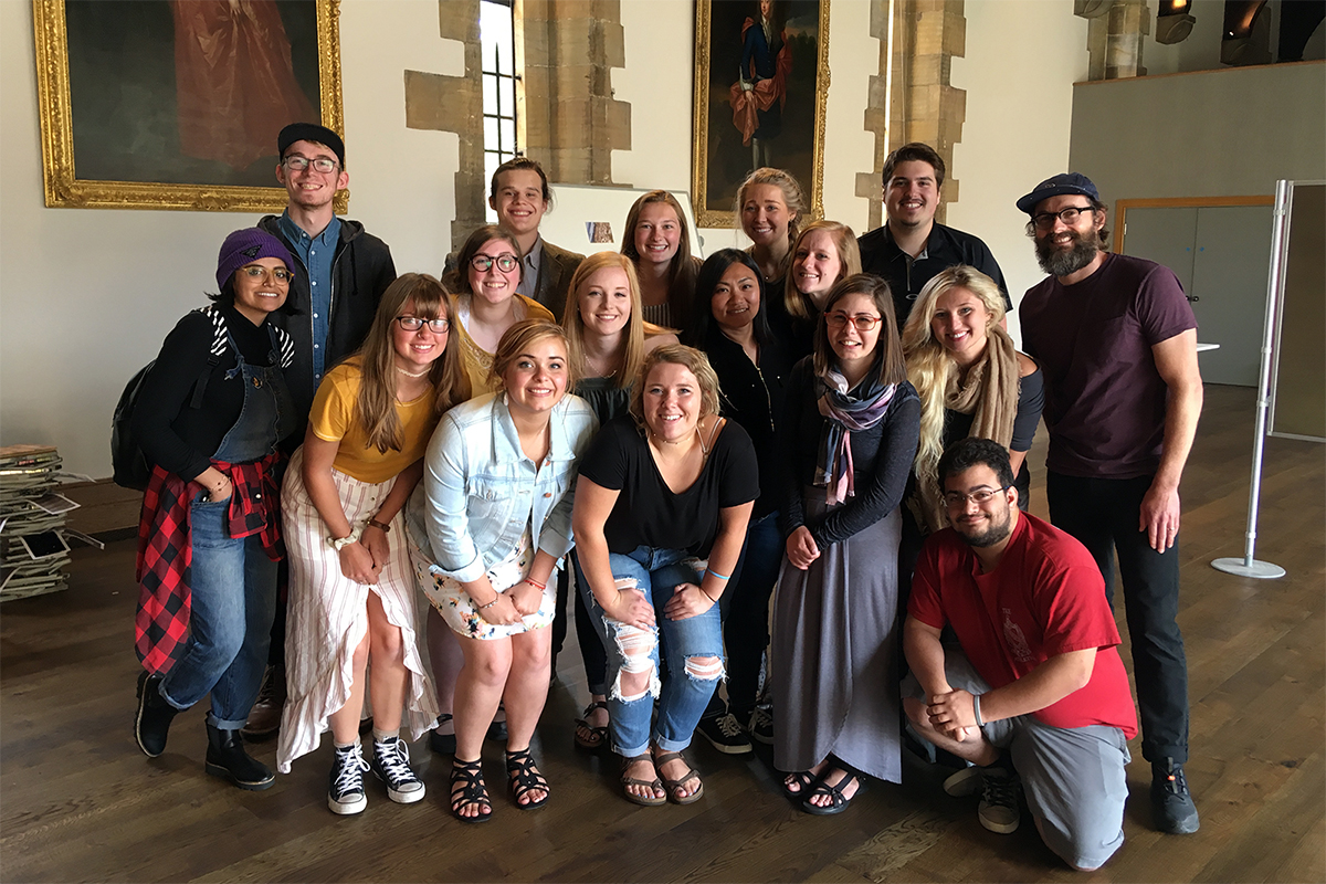 Group photo in front of art on walls
