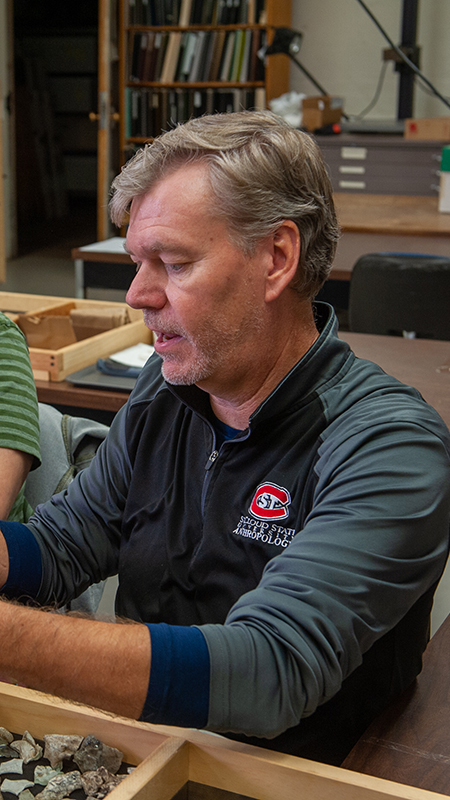 Faculty member working one-on-one with a student during a classroom session