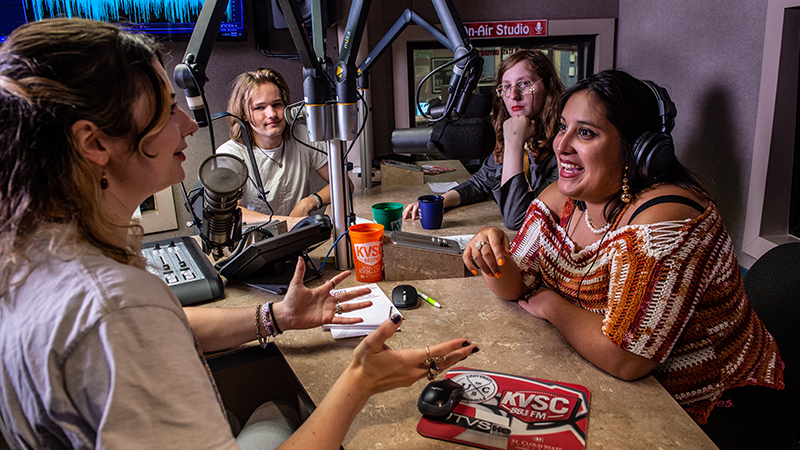 Four SCSU students talk in the KVSC radio studio