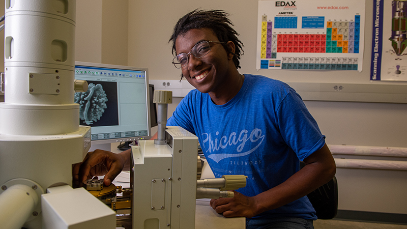 Biology student using imaging equipment in lab