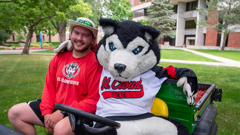 Blizzard mascot driving a lawn cart