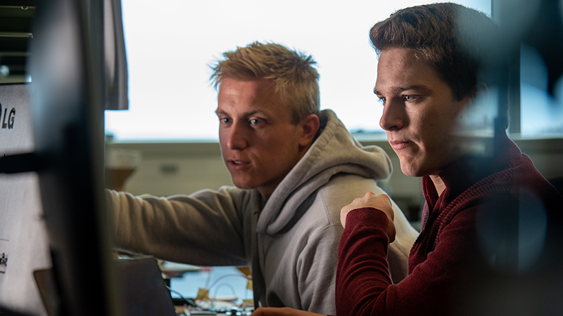 Two engineering students focus on their work in computer lab