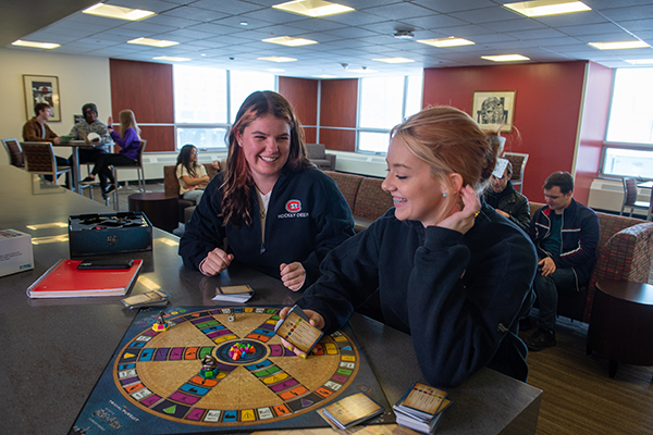 Students playing board game 