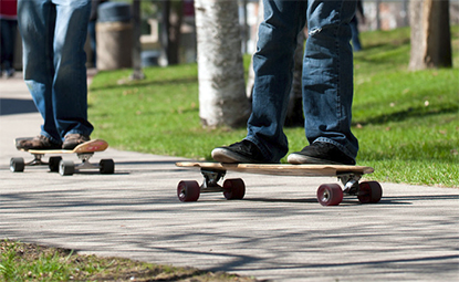 Skateboarders cross campus east of Centennial Hall