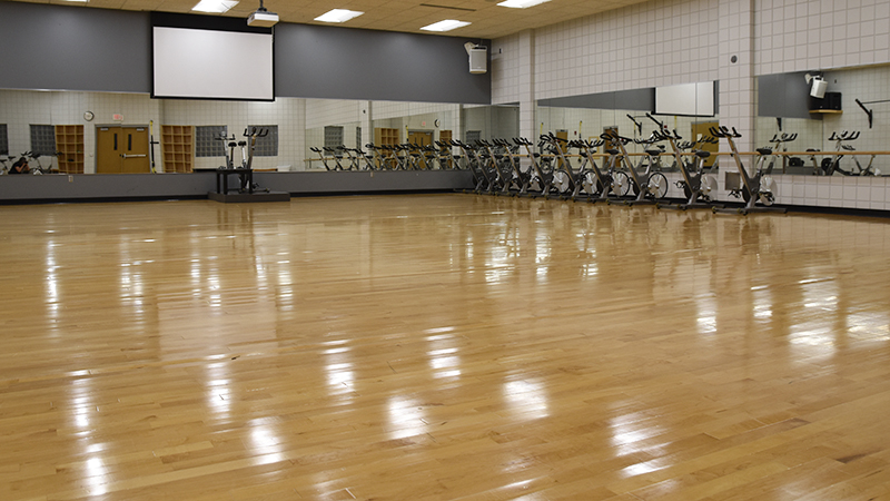Fitness studio with wood floors and mirrors