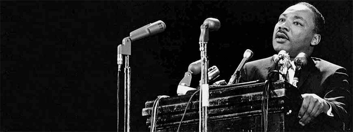 Dr. Martin Luther King speaking at a podium