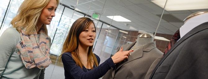 Career Center staff giving professional dress tips to student.