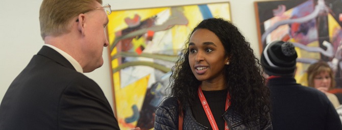 Student connecting with an employer at a job fair