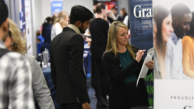 SCSU student talking to employer at a busy career fair