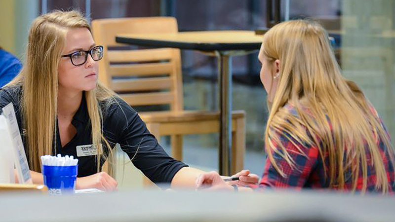 SCSU student speaking with a potential employer in the Career Center