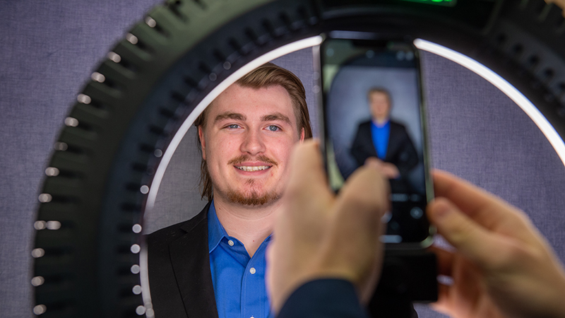 Cell phone taking professional photo of student