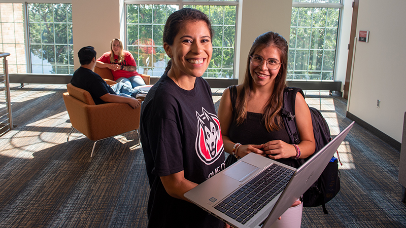 Two smiling with laptop