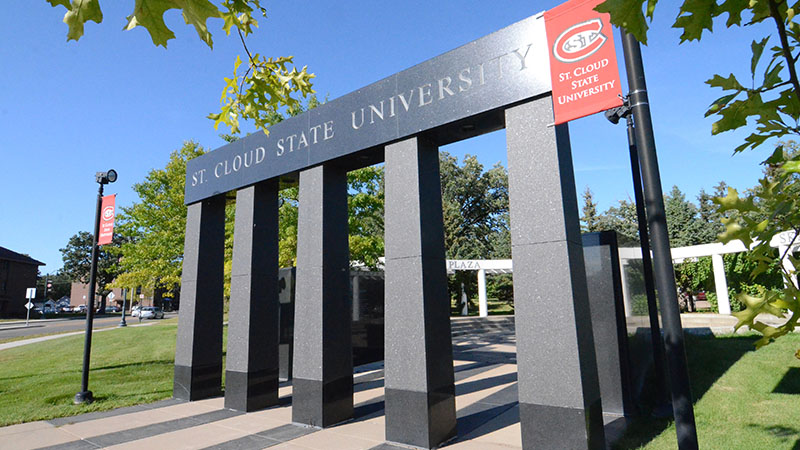 St. Cloud State University Entrance surrounded by clear blue skies and vibrant green grass.