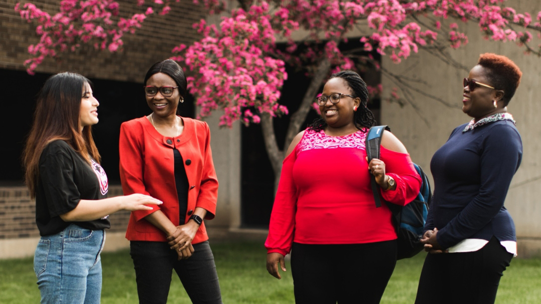 Four students outside Education Building