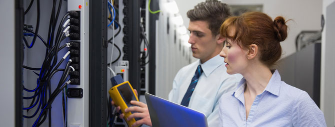 two workers in a server room