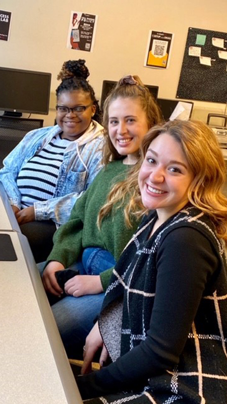 Three students smiling