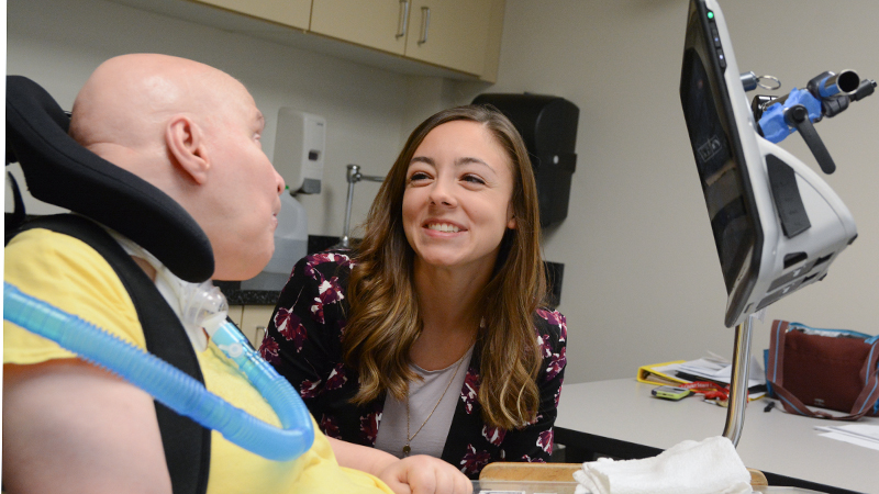 Student with adult client in wheelchair