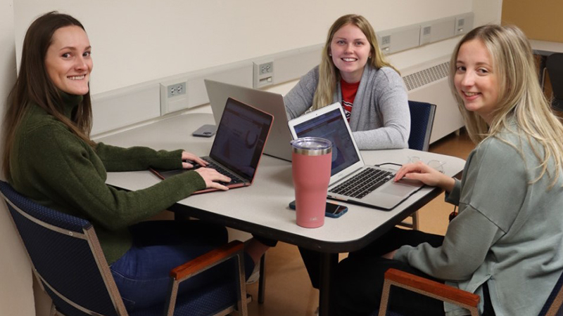 Students learning at table