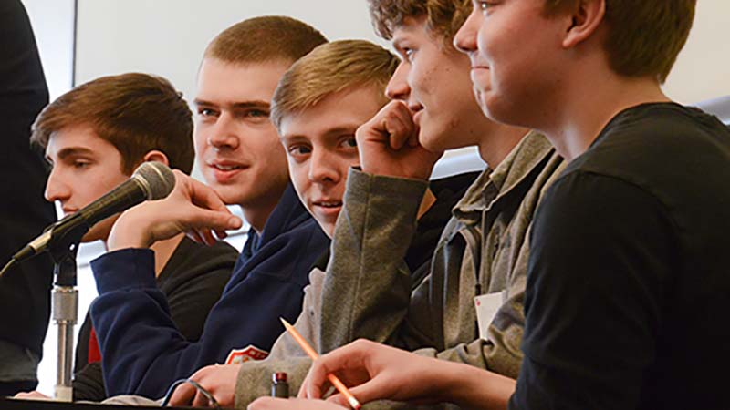 Male students answer a question at the quiz bowl