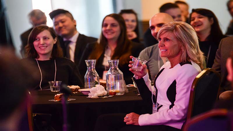 Event attendees smile at a table