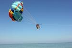 Parasailing in Malaysia, Laani Xiong: On our last day in Malaysia, we had a free day. Never having parasailed before my friend and I decided we'd try it out in Malaysia. This is an image of us going up. We were told that it was jellyfish season this time of the year, and 10 seconds after this photo, our bottoms were touching the water, which gave us both heart attacks thinking we'd be floating in the middle of the ocean during jellyfish season.