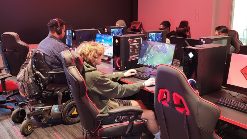 Students playing video games in the Huskies Esports Lounge
