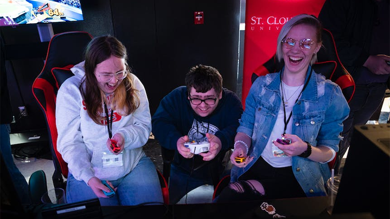 Three students playing a video game