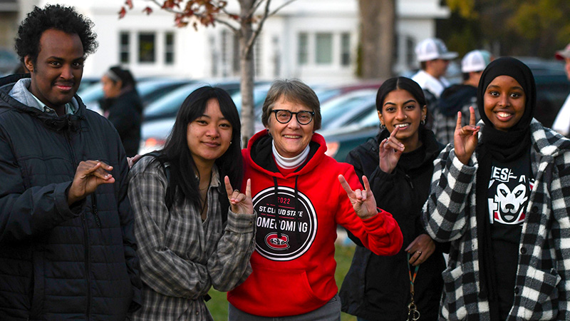 St. Cloud State University President Dr. Robbyn Wacker and four students