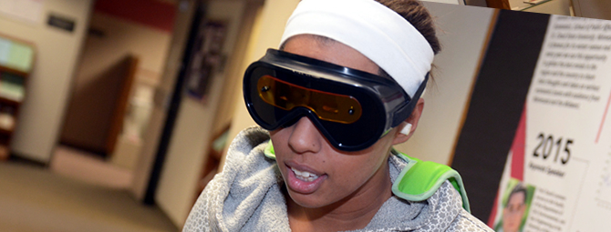 A graduate student wears simulation goggles